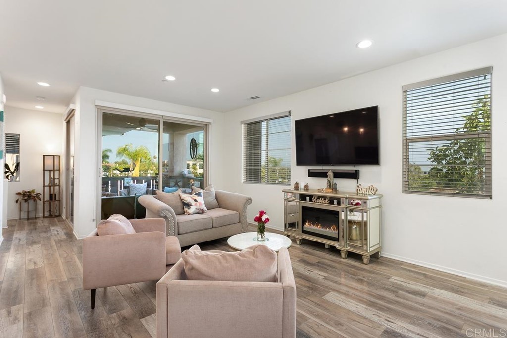 1267 Via Lucero Oceanside, CA 92056 - Photo 13 of 44 a living room with furniture and a flat screen tv
