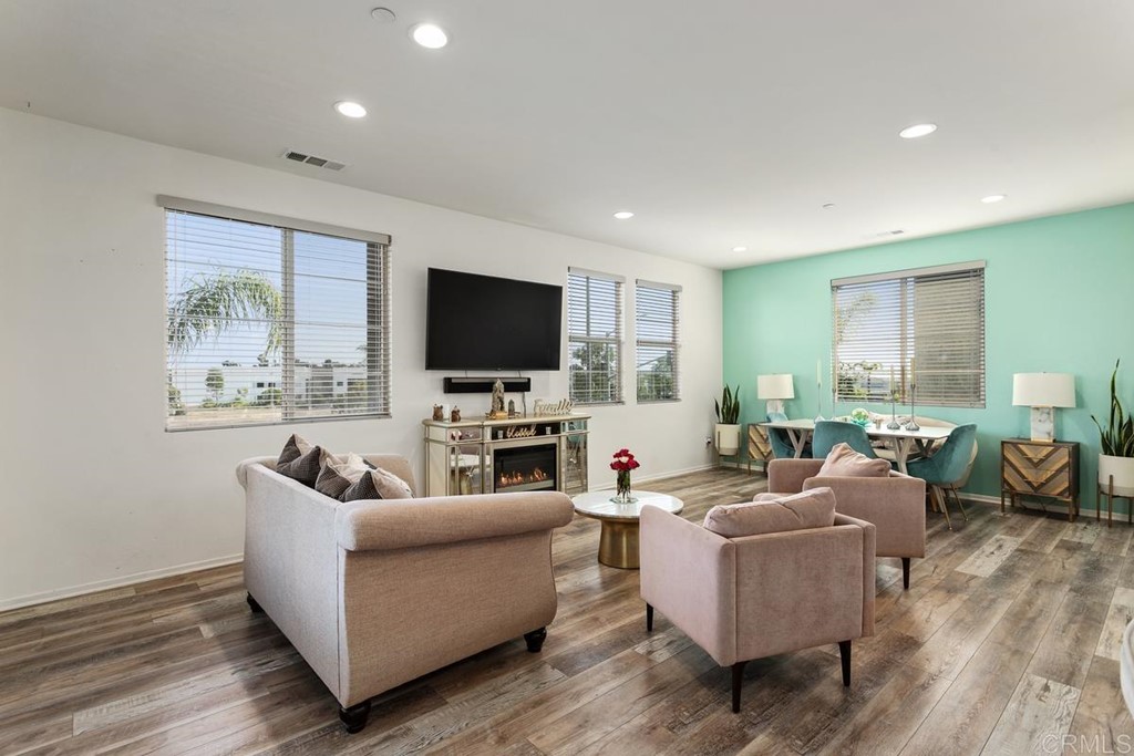 1267 Via Lucero Oceanside, CA 92056 - Photo 14 of 44 a living room with fireplace furniture and a flat screen tv