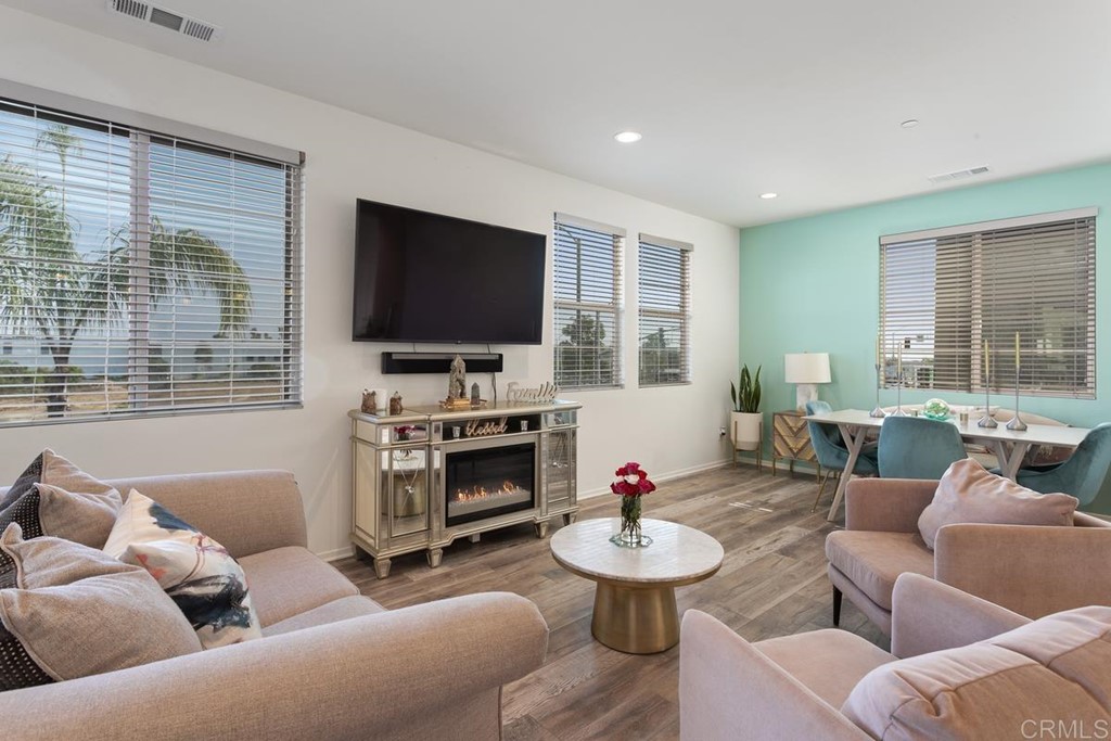 1267 Via Lucero Oceanside, CA 92056 - Photo 15 of 44 a living room with furniture a fireplace and a flat screen tv