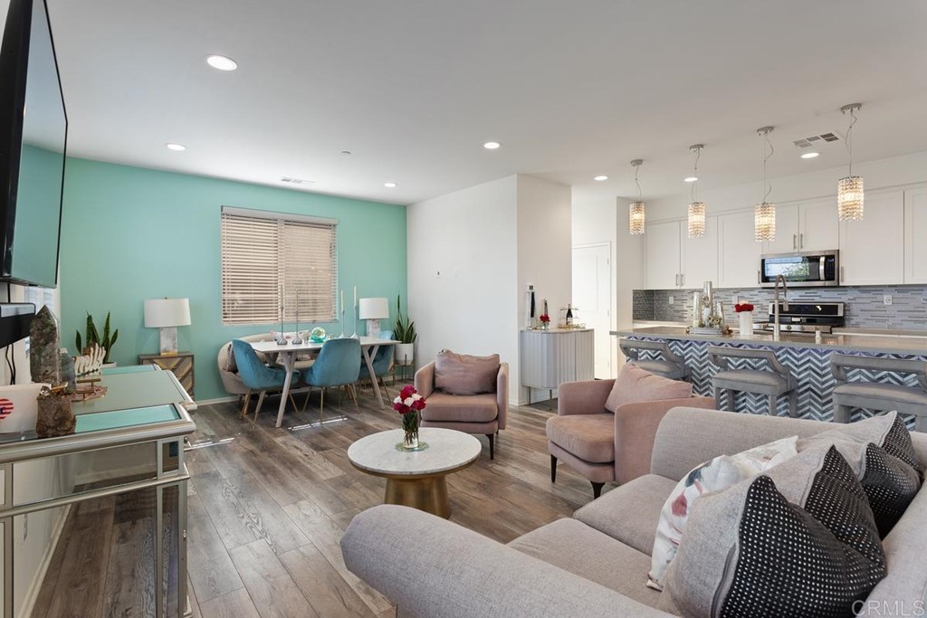 1267 Via Lucero Oceanside, CA 92056 - Photo 16 of 44 a living room with furniture kitchen view and a large window