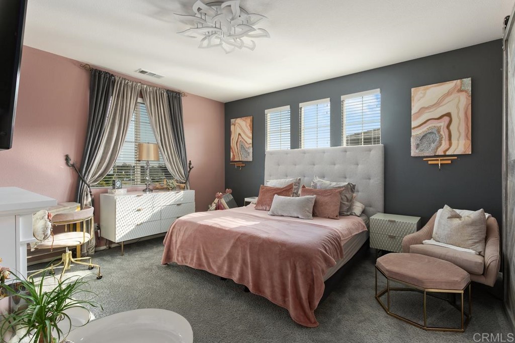 1267 Via Lucero Oceanside, CA 92056 - Photo 24 of 44 a bedroom with a bed and window