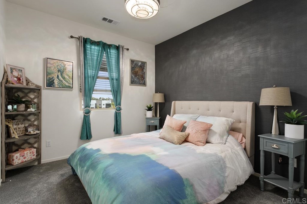 1267 Via Lucero Oceanside, CA 92056 - Photo 29 of 44 a bedroom with a bed and a window