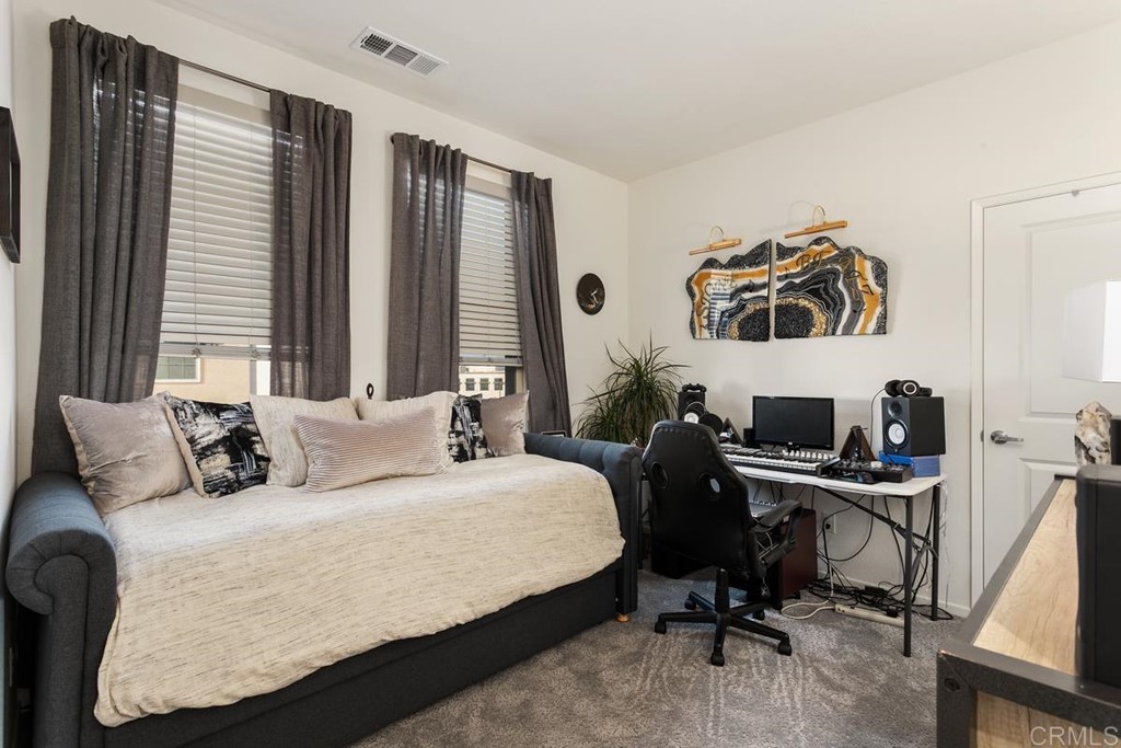 1267 Via Lucero Oceanside, CA 92056 - Photo 31 of 44 a bedroom with a bed and a desk