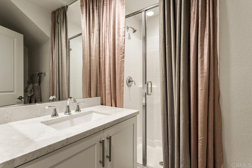 1267 Via Lucero Oceanside, CA 92056 - Photo 35 of 44 a bathroom with a granite countertop sink and a mirror