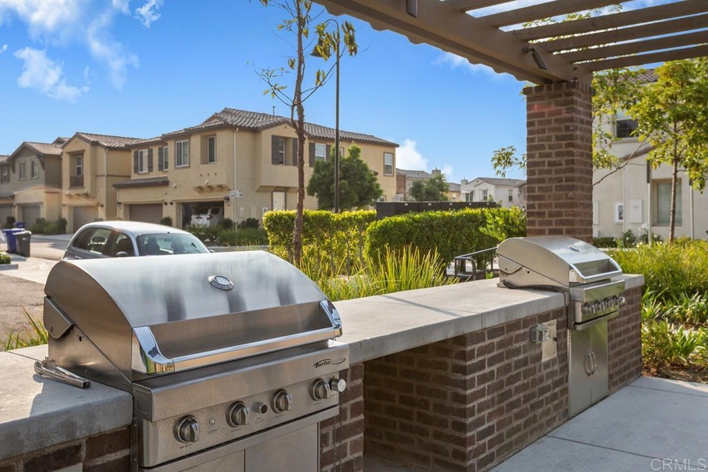 1267 Via Lucero Oceanside, CA 92056 - Photo 41 of 44 a view of a patio with table and chairs and potted plants