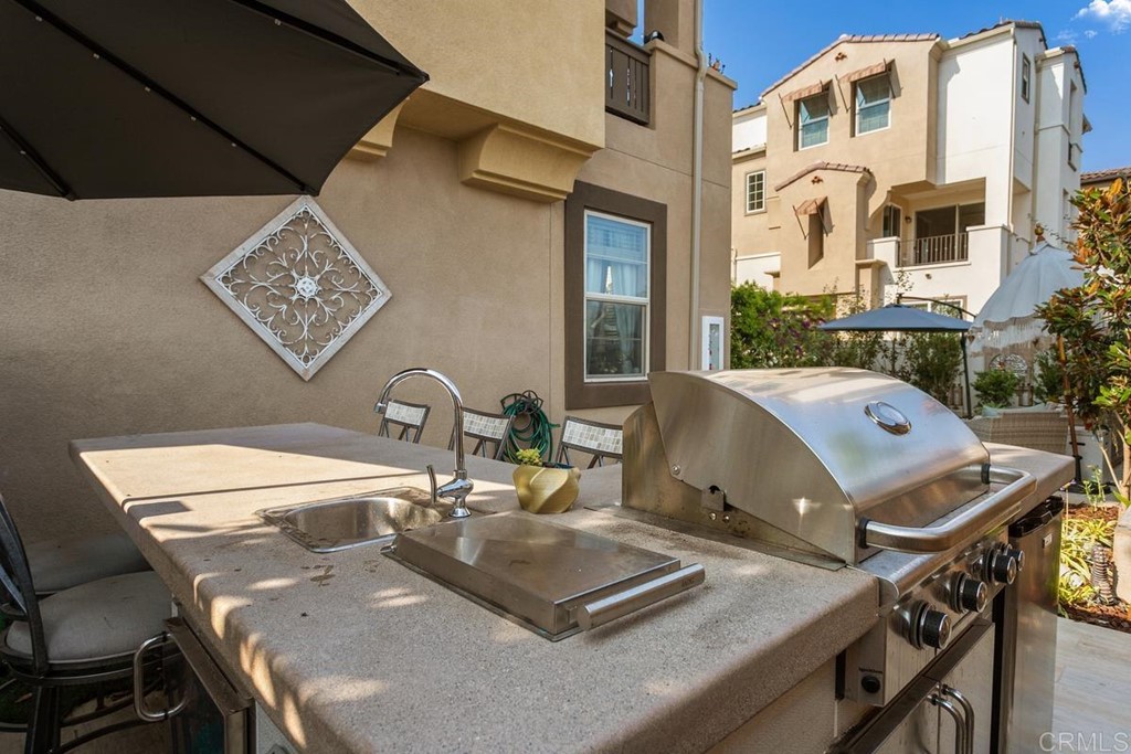 1267 Via Lucero Oceanside, CA 92056 - Photo 9 of 44 a view of a kitchen with a sink and a stove