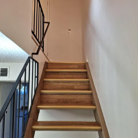 an empty room with wooden floor and a window
