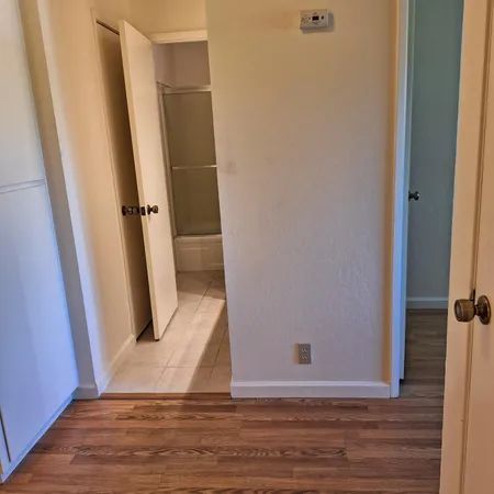 a white toilet sitting next to a shower