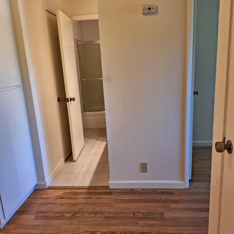 a white toilet sitting next to a shower