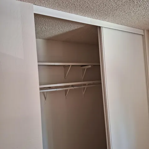 a view of an empty walk in closet