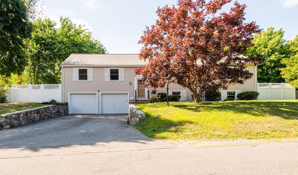 a view of house with swimming pool and yard