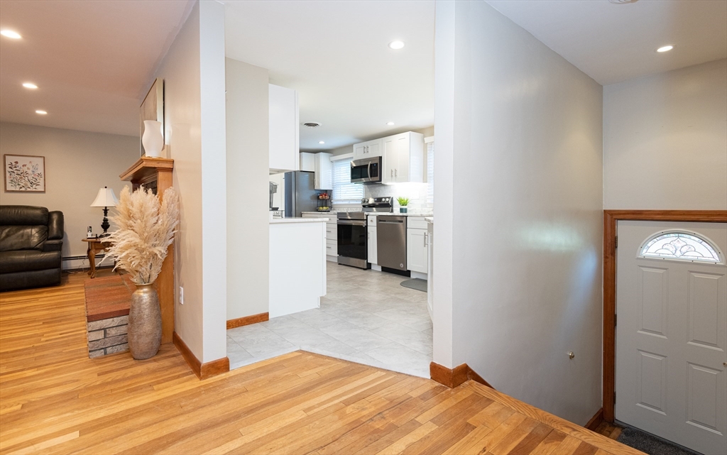 251 Centre Street Danvers, MA 01923 - Photo 11 of 42 a kitchen with stainless steel appliances kitchen island granite countertop a refrigerator and a sink
