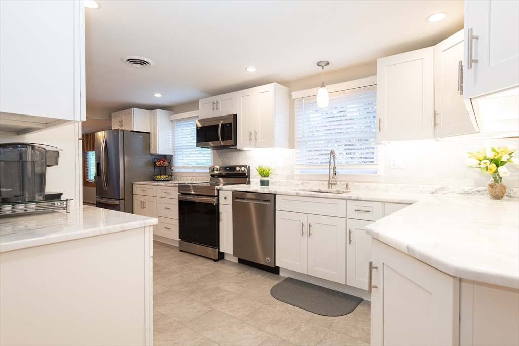 251 Centre Street Danvers, MA 01923 - Photo 12 of 42 a kitchen with a sink stove and refrigerator