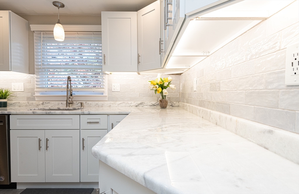 251 Centre Street Danvers, MA 01923 - Photo 13 of 42 a large white kitchen with granite countertop a sink