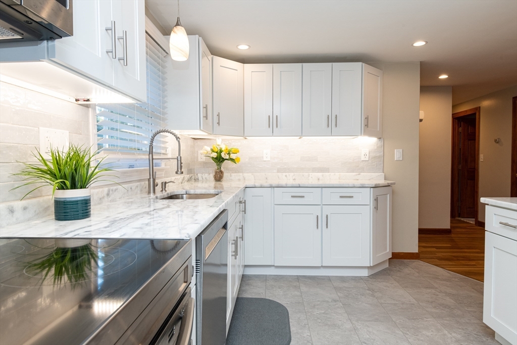 251 Centre Street Danvers, MA 01923 - Photo 16 of 42 a kitchen with a refrigerator a sink and cabinets