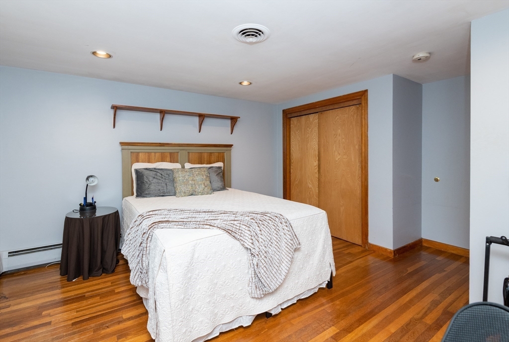 251 Centre Street Danvers, MA 01923 - Photo 34 of 42 a bedroom with a bed and wooden floor