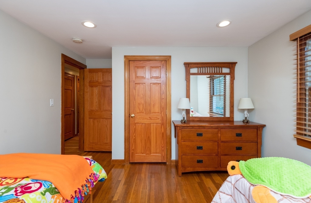 251 Centre Street Danvers, MA 01923 - Photo 36 of 42 a bedroom with a bed and wooden floor