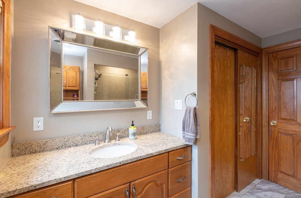 251 Centre Street Danvers, MA 01923 - Photo 39 of 42 a bathroom with a granite countertop sink and a mirror