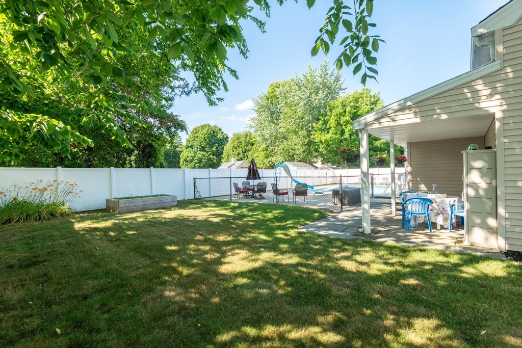 251 Centre Street Danvers, MA 01923 - Photo 4 of 42 a backyard of a house with table and chairs