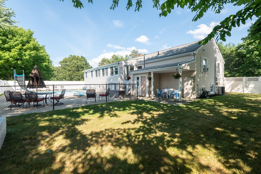 251 Centre Street Danvers, MA 01923 - Photo 5 of 42 a view of a house with swimming pool lawn chairs and a yard tree s