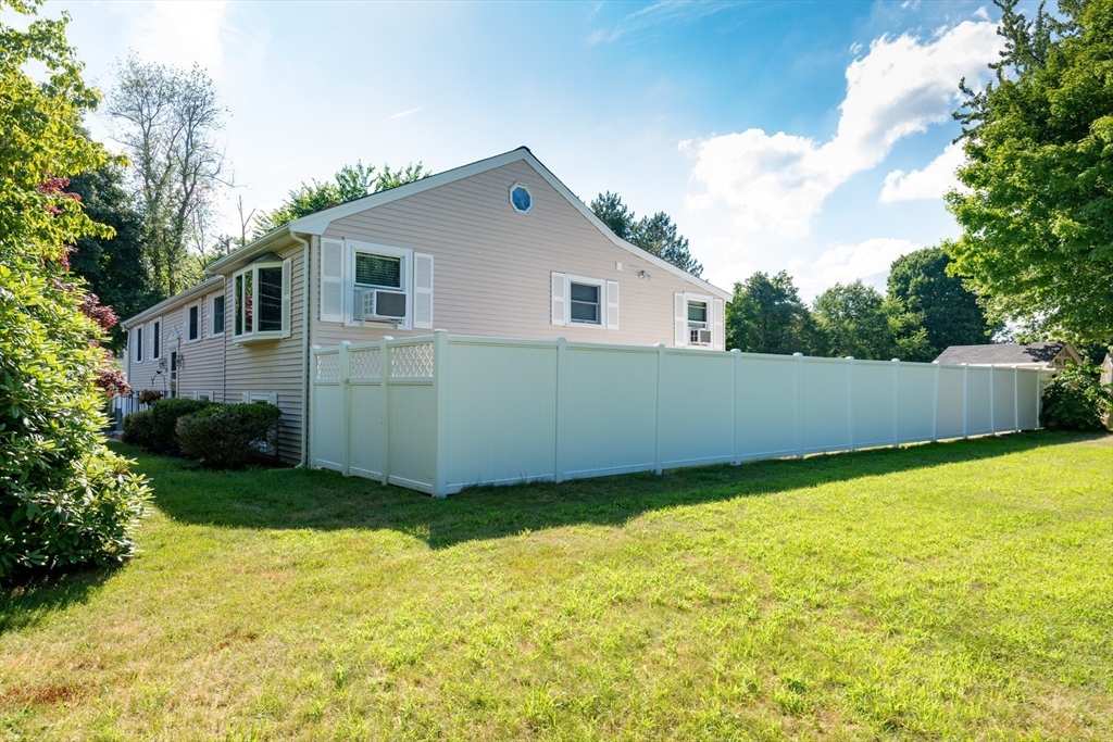 251 Centre Street Danvers, MA 01923 - Photo 10 of 42 a view of a backyard with plants and large trees