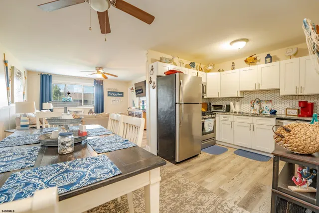 a kitchen with stainless steel appliances granite countertop a refrigerator stove oven and white cabinets