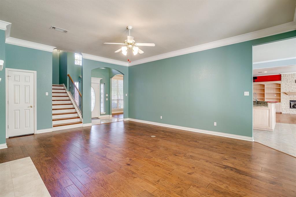 312 Oak Ridge Drive Burleson, TX 76028 - Photo 14 of 40 wooden floor in an empty room with a window