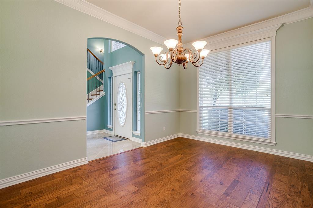 312 Oak Ridge Drive Burleson, TX 76028 - Photo 15 of 40 wooden floor in an empty room with a window