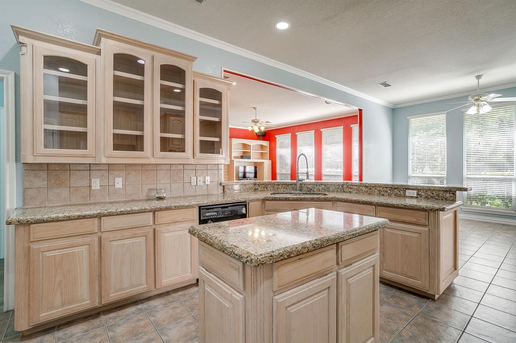 312 Oak Ridge Drive Burleson, TX 76028 - Photo 18 of 40 a kitchen with granite countertop a sink and cabinets
