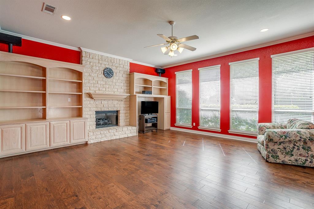312 Oak Ridge Drive Burleson, TX 76028 - Photo 23 of 40 a view of livingroom with furniture wooden floor fireplace and window