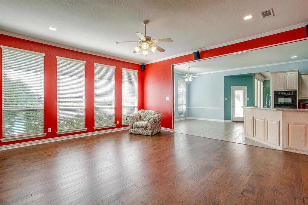 312 Oak Ridge Drive Burleson, TX 76028 - Photo 24 of 40 a view of an empty room with wooden floor and a large window