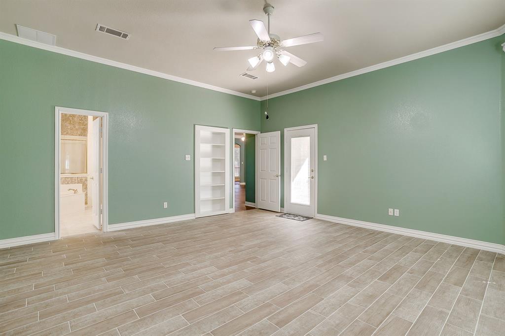 312 Oak Ridge Drive Burleson, TX 76028 - Photo 27 of 40 a view of an empty room with window and chandelier fan