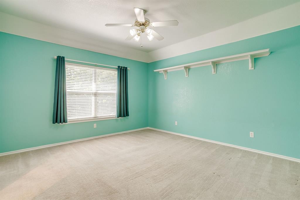 312 Oak Ridge Drive Burleson, TX 76028 - Photo 32 of 40 an empty room with windows and fan
