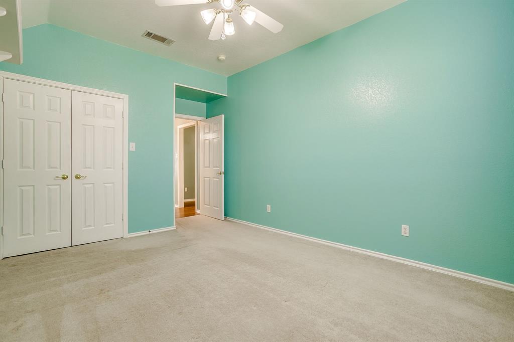 312 Oak Ridge Drive Burleson, TX 76028 - Photo 33 of 40 an empty room with a chandelier fan and closet