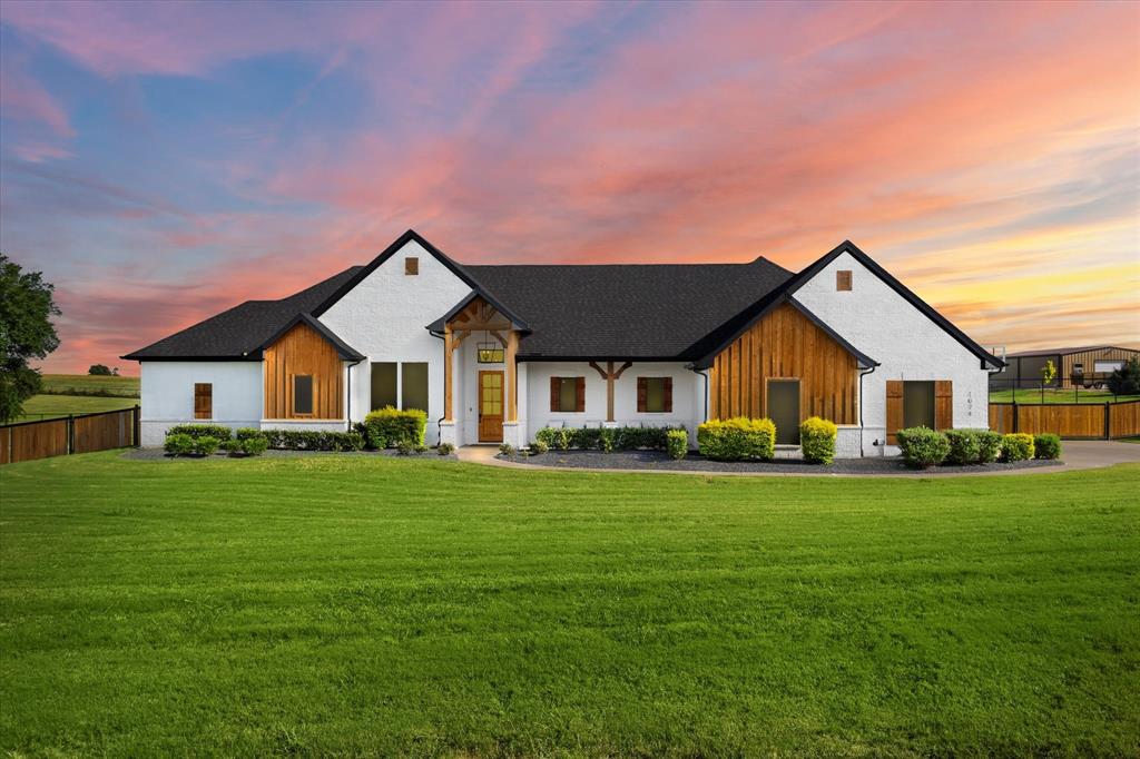 1074 Pioneer Crossing Weatherford, TX 76088 - Photo 1 of 36 a front view of a house with a yard and garage