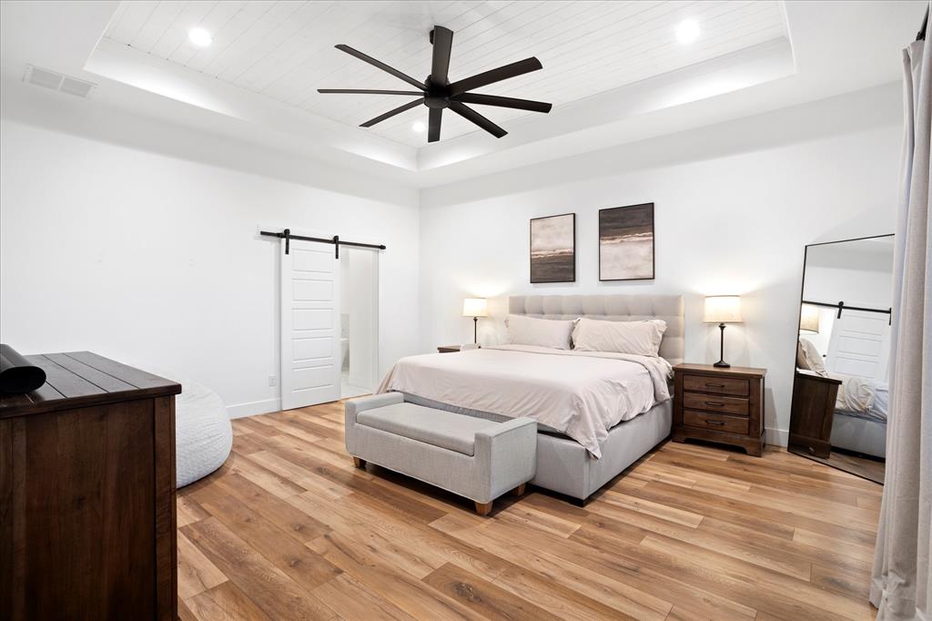 1074 Pioneer Crossing Weatherford, TX 76088 - Photo 16 of 36 a spacious bedroom with a bed and a ceiling fan