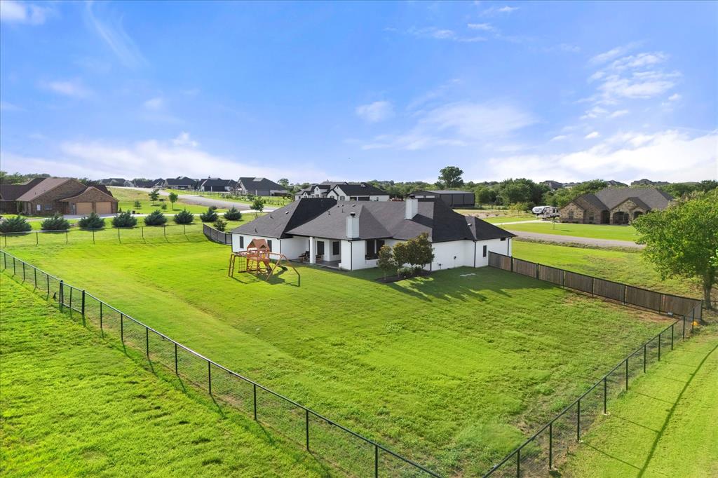 1074 Pioneer Crossing Weatherford, TX 76088 - Photo 34 of 36 a view of a big house with a big yard and large trees