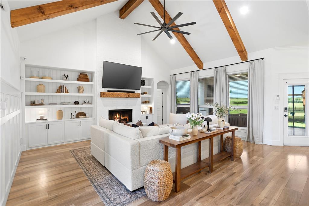 1074 Pioneer Crossing Weatherford, TX 76088 - Photo 8 of 36 a living room with furniture a flat screen tv and a fireplace