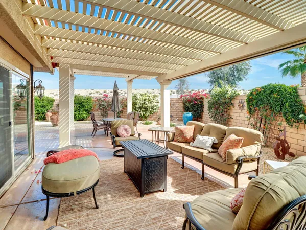a living room with furniture and floor to ceiling window