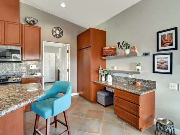a kitchen with stainless steel appliances granite countertop a stove microwave and sink