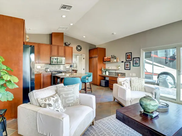 a living room with furniture kitchen view and a table