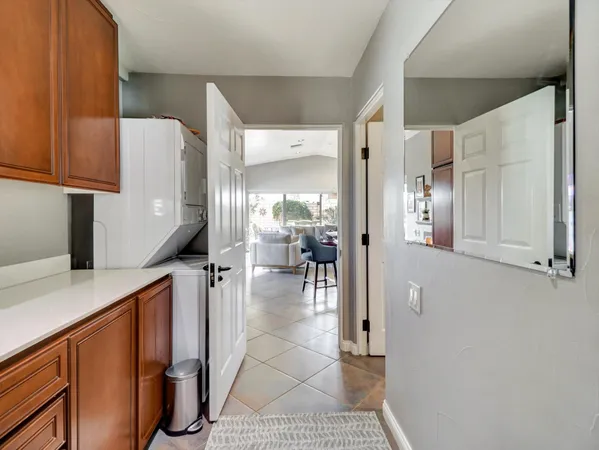 a view of a patio with table and chairs with wooden floor and fence