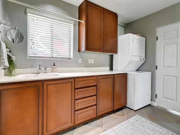 a view of a patio with table and chairs under an umbrella