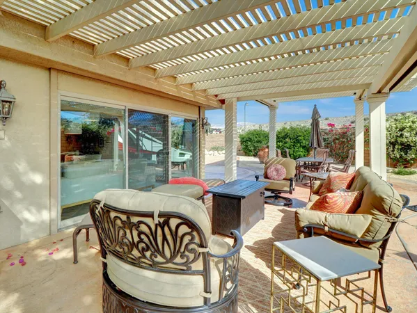 a living room with furniture flat screen tv and a large window