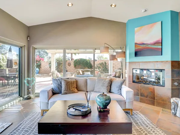 a living room with fireplace furniture and a flat screen tv