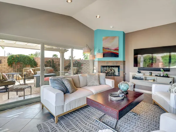 a living room with fireplace furniture and a flat screen tv