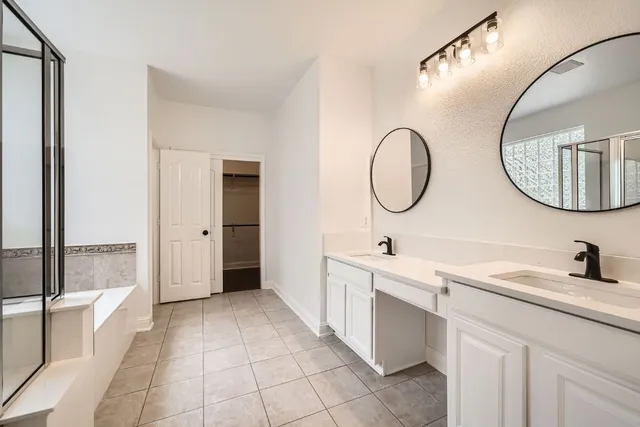 a bathroom with a double vanity sink and a mirror
