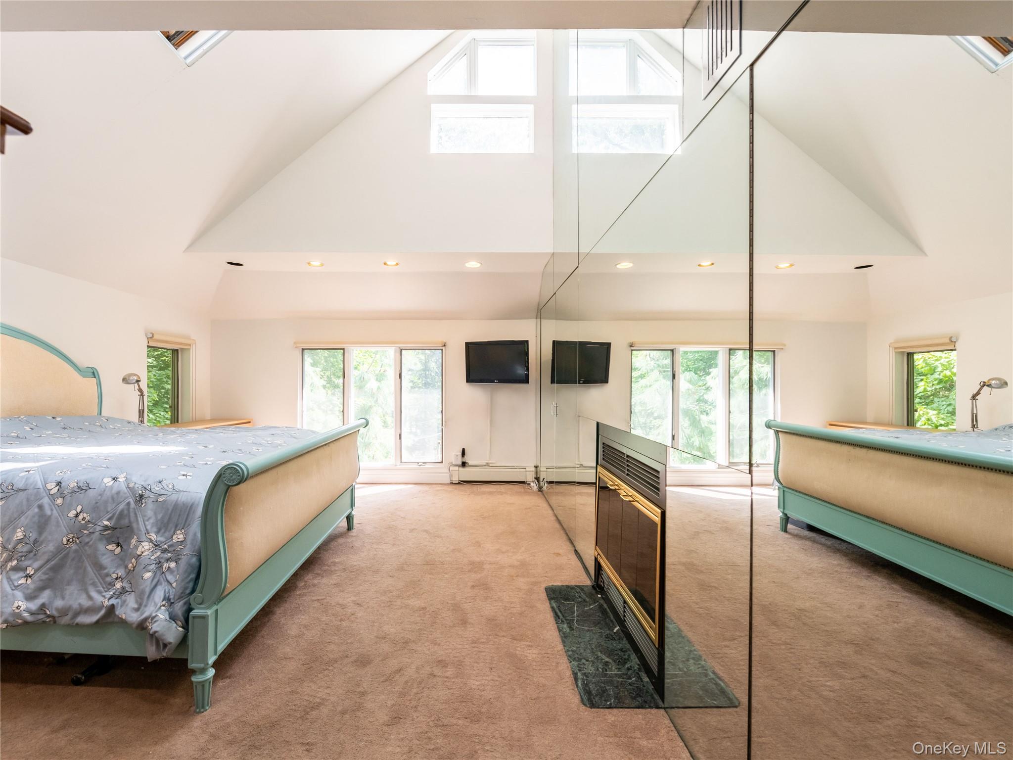 100 Station Road Great Neck, NY 11023 - Photo 16 of 29 a spacious bedroom with a large bed and a large window