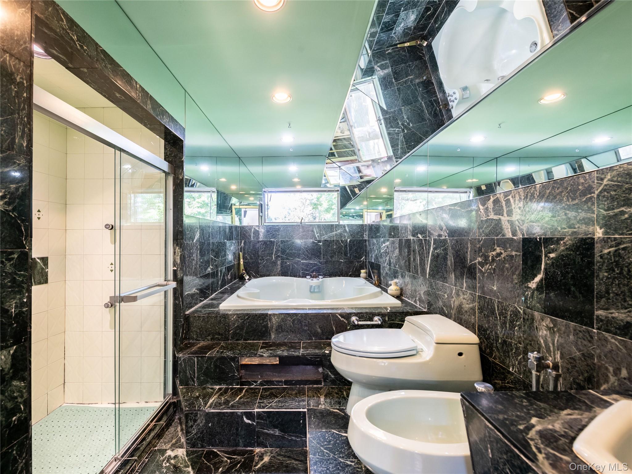 100 Station Road Great Neck, NY 11023 - Photo 18 of 29 a bathroom with a sink toilet and shower