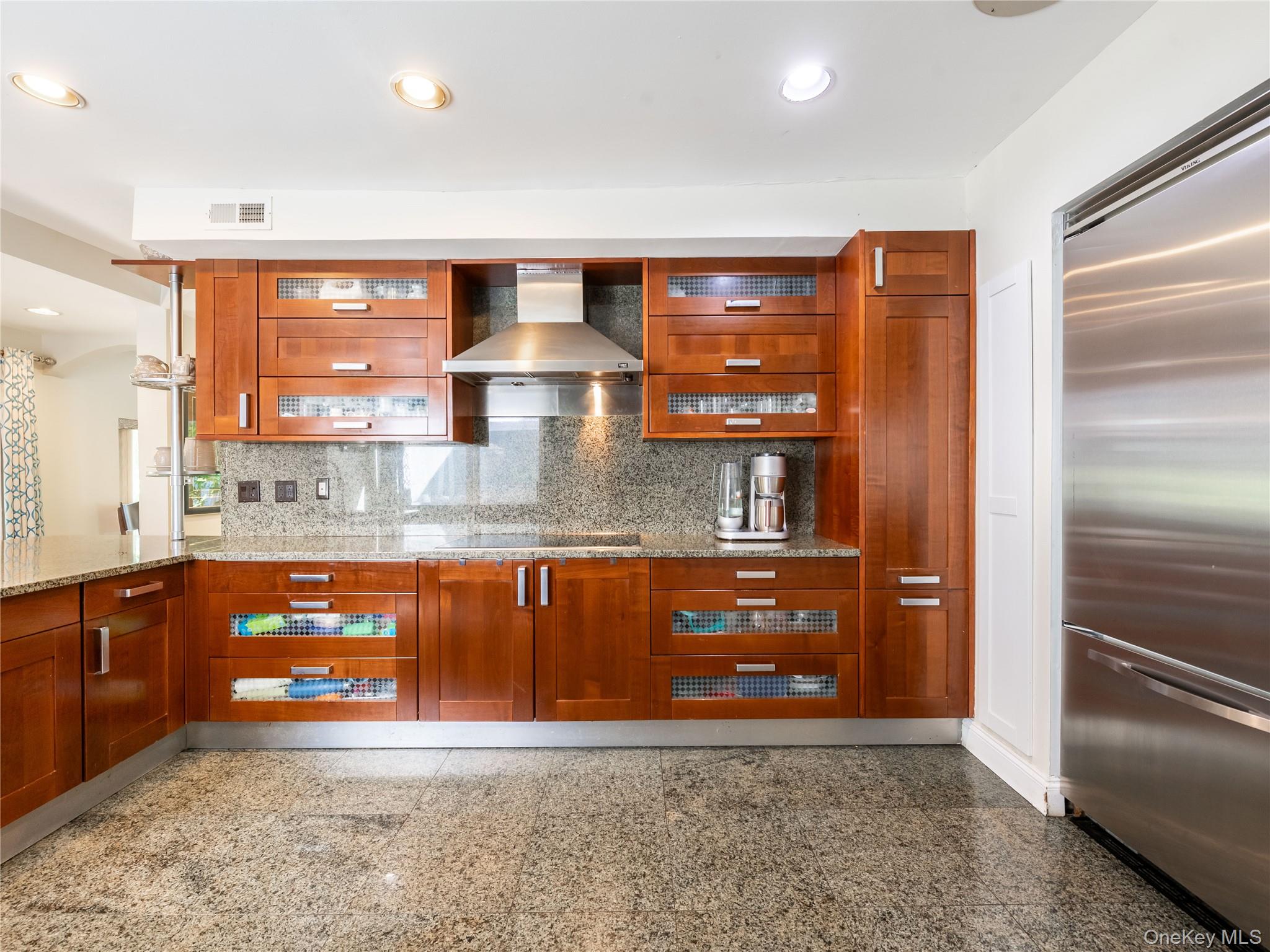 100 Station Road Great Neck, NY 11023 - Photo 2 of 29 a large kitchen with stainless steel appliances granite countertop a refrigerator a oven and a sink with granite countertops